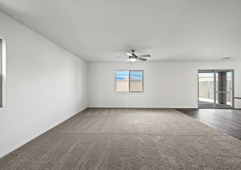 Spacious family room with carpet and a ceiling fan