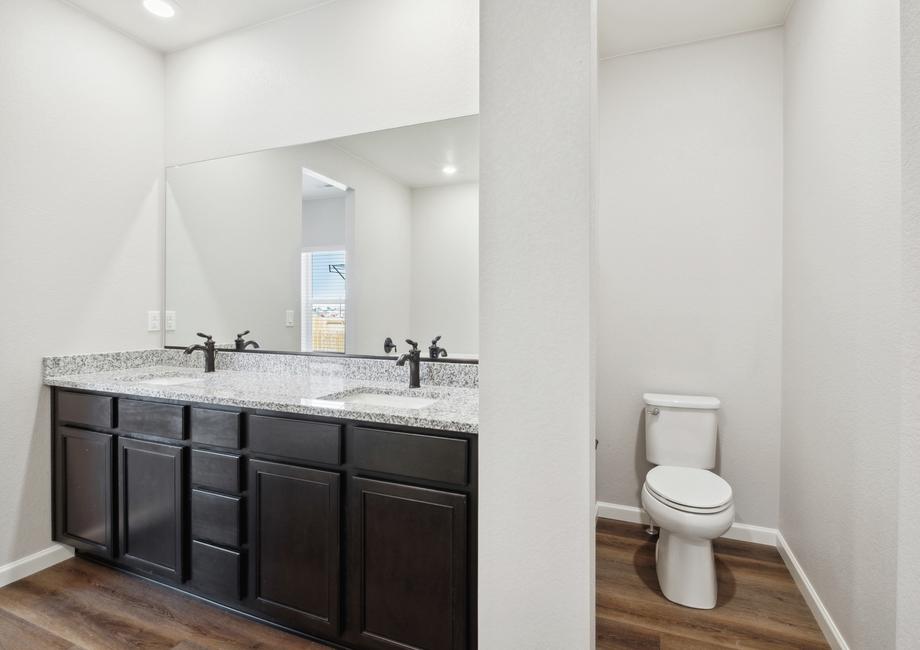 Master bathroom features a private restroom.